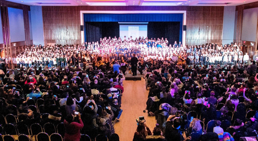 Socrates-Demosthenes students host 450 children to sing