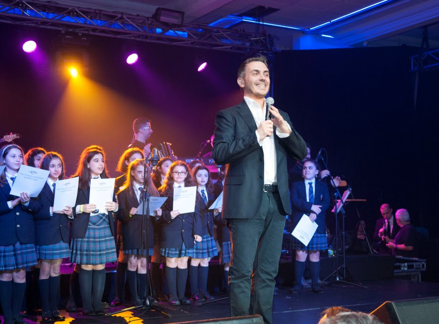 The Socrates II choir on stage with Mihalis Hatzigiannis